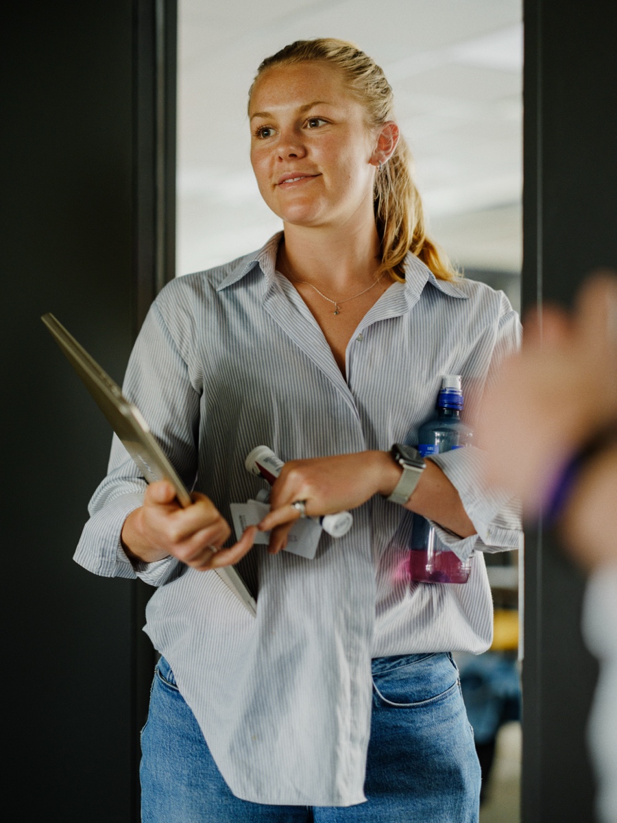 A colleague inspecting a piece of hardware in the light